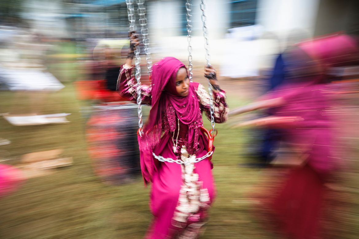 A young Muslim girl enjoys a swing ride at Eastleigh High School in Nairobi, Kenya, 04 June 2019. Muslims around the world are celebrating Eid al-Fitr, the three day festival marking the end of the Mu