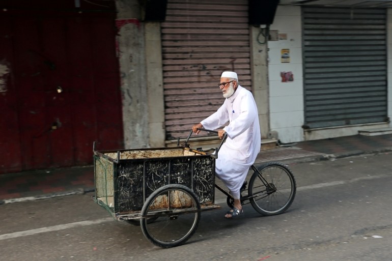 A man rides his bicycle cart past closed shops as Palestinians call for a general strike to protest against Bahrain''s economic workshop for U.S. Middle East peace plan, in the southern Gaza Strip