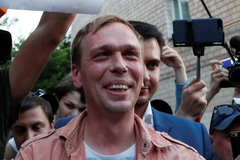 Russian journalist Ivan Golunov (R), who was freed from house arrest after police abruptly dropped drugs charges against him, meets with the media and his supporters outside the office of criminal inv