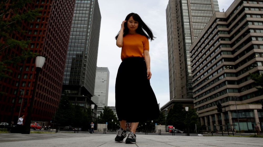 Yumi Ishikawa poses in a business district during an interview with Reuters in Tokyo