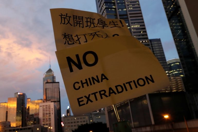 A placard is displayed during a protest following a day of violence over a proposed extradition bill, near the Legislative Council building in Hong Kong, China, June 13, 2019