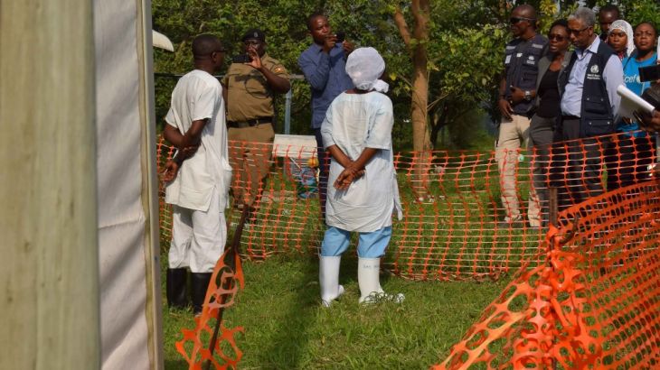 World Health Organization (WHO) officials talk to Ugandan medical staff as they inspect ebola preparedness facilities at the Bwera general hospital near the border with the DR Congo