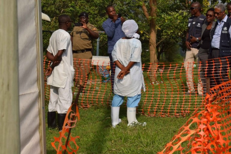 World Health Organization (WHO) officials talk to Ugandan medical staff as they inspect ebola preparedness facilities at the Bwera general hospital near the border with the DR Congo