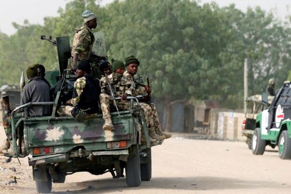 Nigerian military ride on their truck as they secure the area where a man was killed by suspected militants during an attack around Polo area of Maiduguri, Nigeria February 16, 2019. REURS/Afolabi Sot