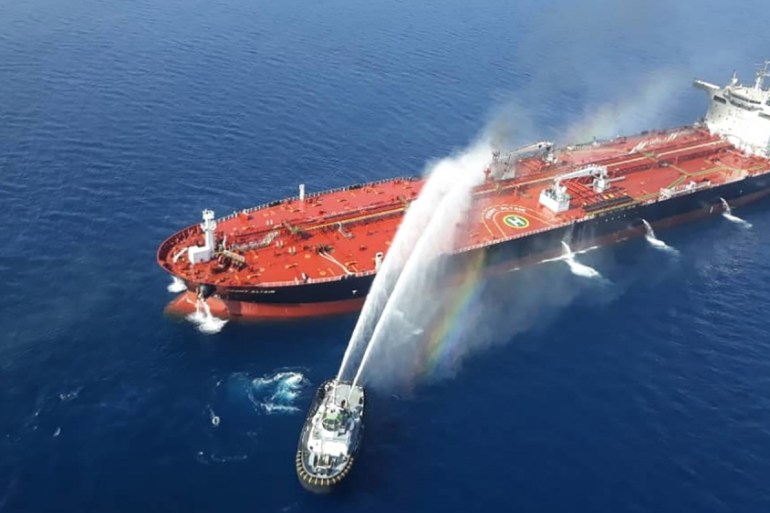 A picture obtained by AFP from Iranian news agency Tasnim on June 13, 2019 reportedly shows an Iranian navy boat trying to control fire from Norwegian owned Front Altair tanker said to have been attac