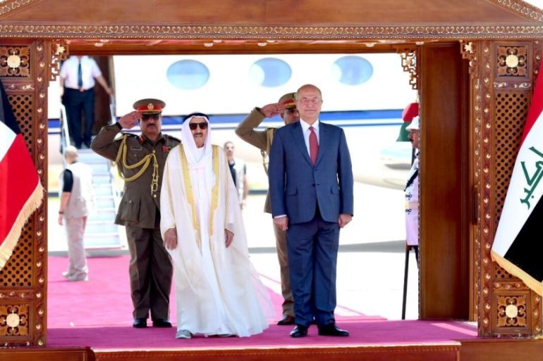 Iraq''s President Barham Salih stands with Kuwait''s ruling emir Sheikh Sabah al-Ahmad al-Sabah during a welcoming ceremony in Baghdad