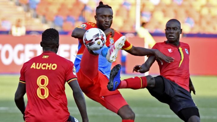 DR Congo's midfielder Merveille Bope (C) fights for the ball with Uganda's forward Patrick Kaddu (R) during the 2019 Africa Cup of Nations (CAN) football match between DR Congo and Uganda at Cairo Int