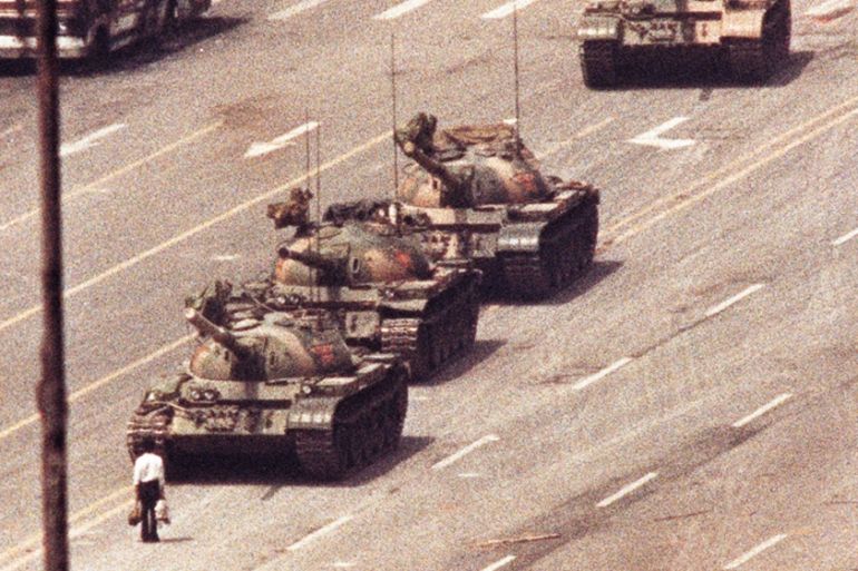 File photo of a man standing in front of a convoy of tanks in the Avenue of Eternal Peace in Tiananmen Square in Beijing