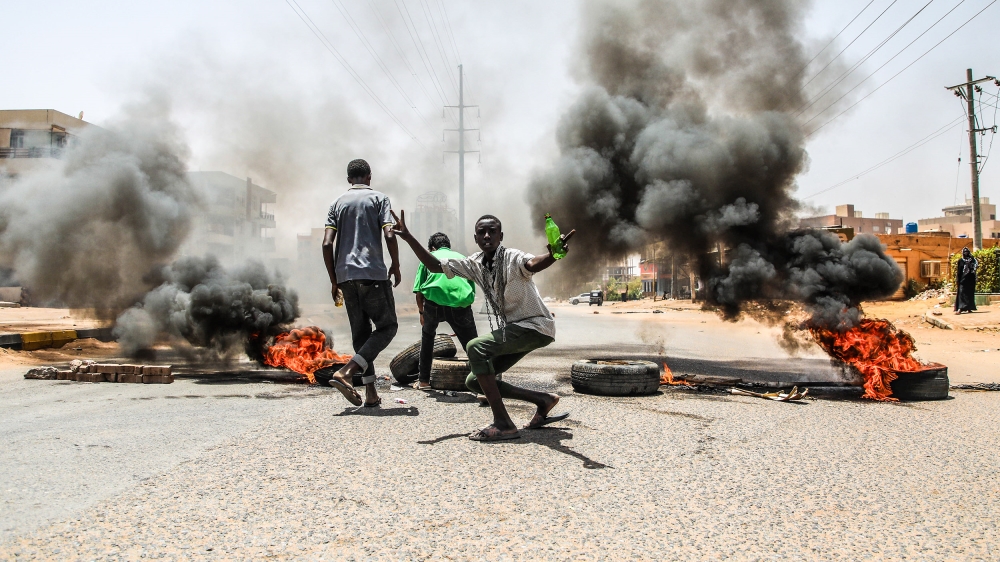 Demonstrations in Sudan- - KHARTOUM, SUDAN - JUNE 03 : Sudanese protesters burn tyres and set up barricades on roads to army headquarters after the intervention of Sudanese army, during a demonstratio