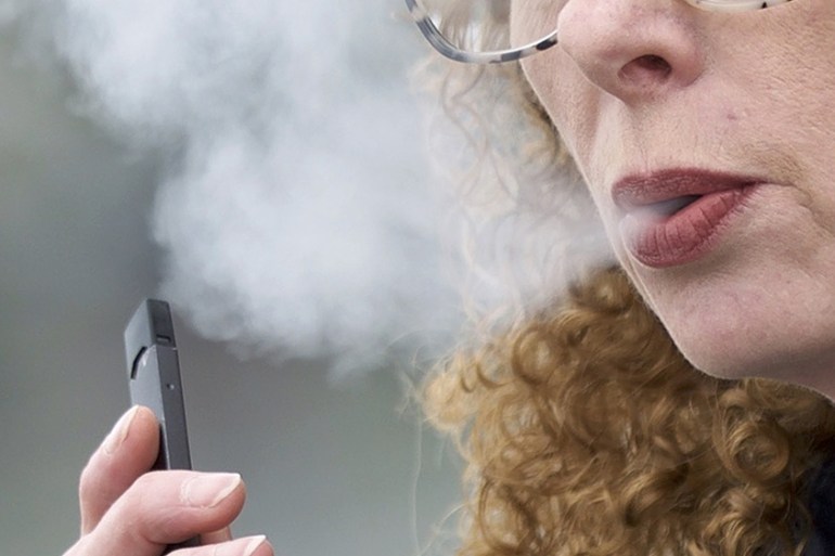 Woman puffing an e-cigarette in Washington state