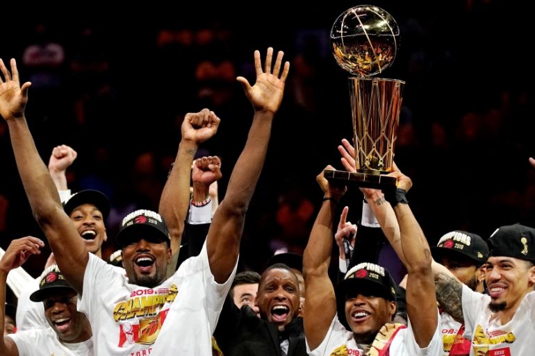 The Toronto Raptors celebrates with the Larry O"Brien Trophy after beating the Golden State Warriors in game six of the 2019 NBA Finals at Oracle Arena
