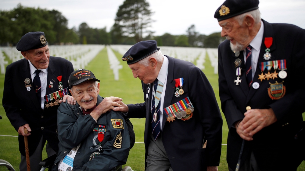 World War Two D-Day veterans, including Richard Llewellyn and Mervyn Kersh from Britain and Norman Duncan from the U.S., attend a ceremony at Normandy American Cemetery and Memorial situated above Oma