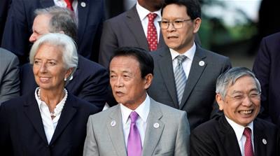 Japan's Finance Minister Taro Aso stands next to IMF Managing Director Christine Lagarde 