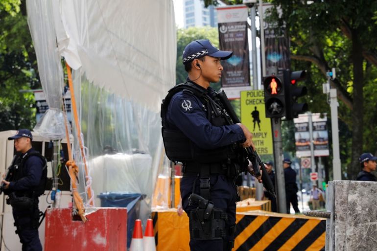 Police stand guards outside St. Regis hotel in Singapore