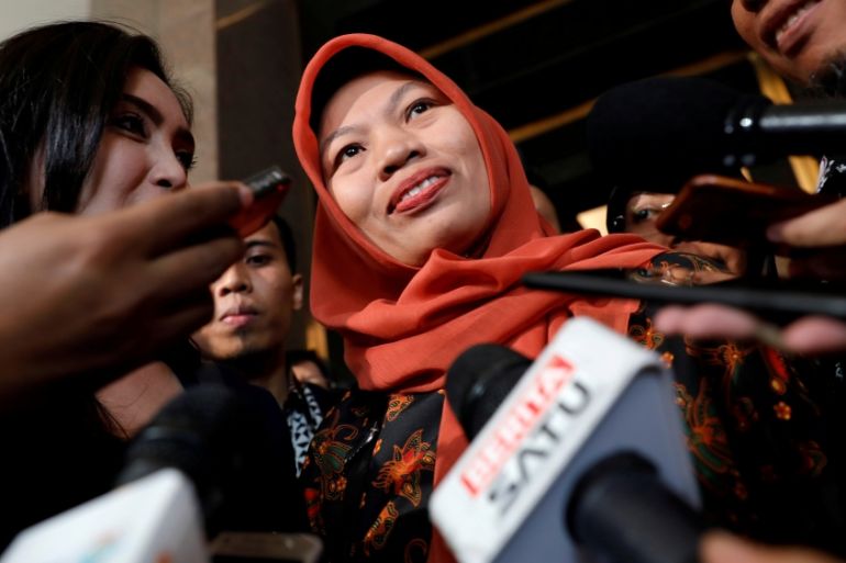 Baiq Nuril Maknun reacts to journalists as she arrives at Law and Human Rights ministry office in Jakarta