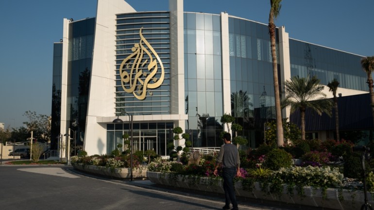 Al Jazeera building / Al Jazeera Logo [Sorin Furcoi/Al Jazeera]