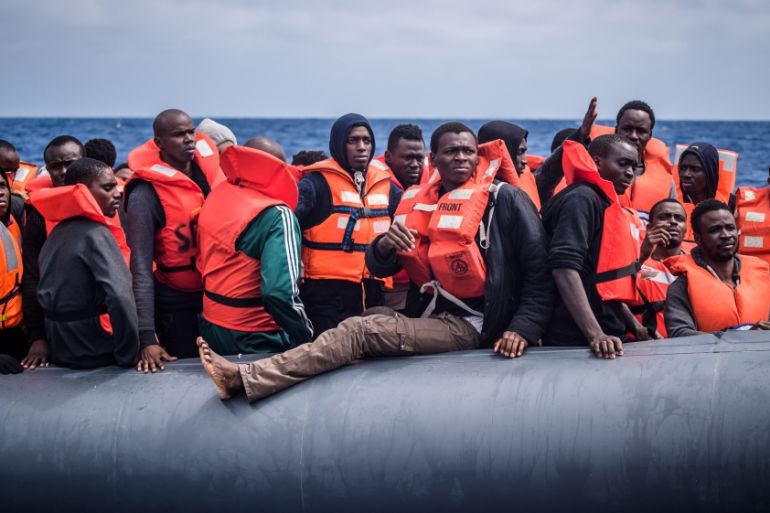 Refugees on a rubber dinghy are rescued by members of the NGO ''SOS Mediterranee''