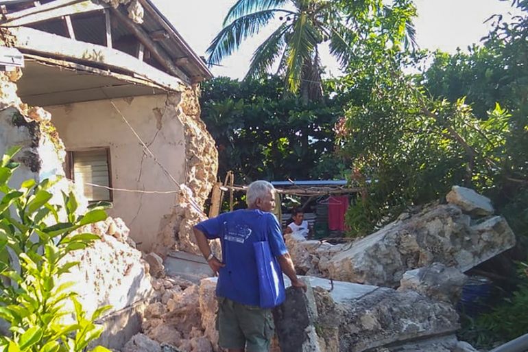 A resident looks at damaged houses in Itbayat town, Batanes islands, northern Philippines following the earthquakes Saturday, July 27, 2019.