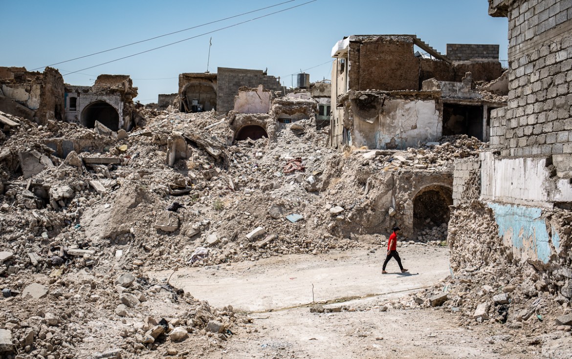 A man walks through the rubble of the old city of Mosul [Tom Peyre-Costa/NRC]