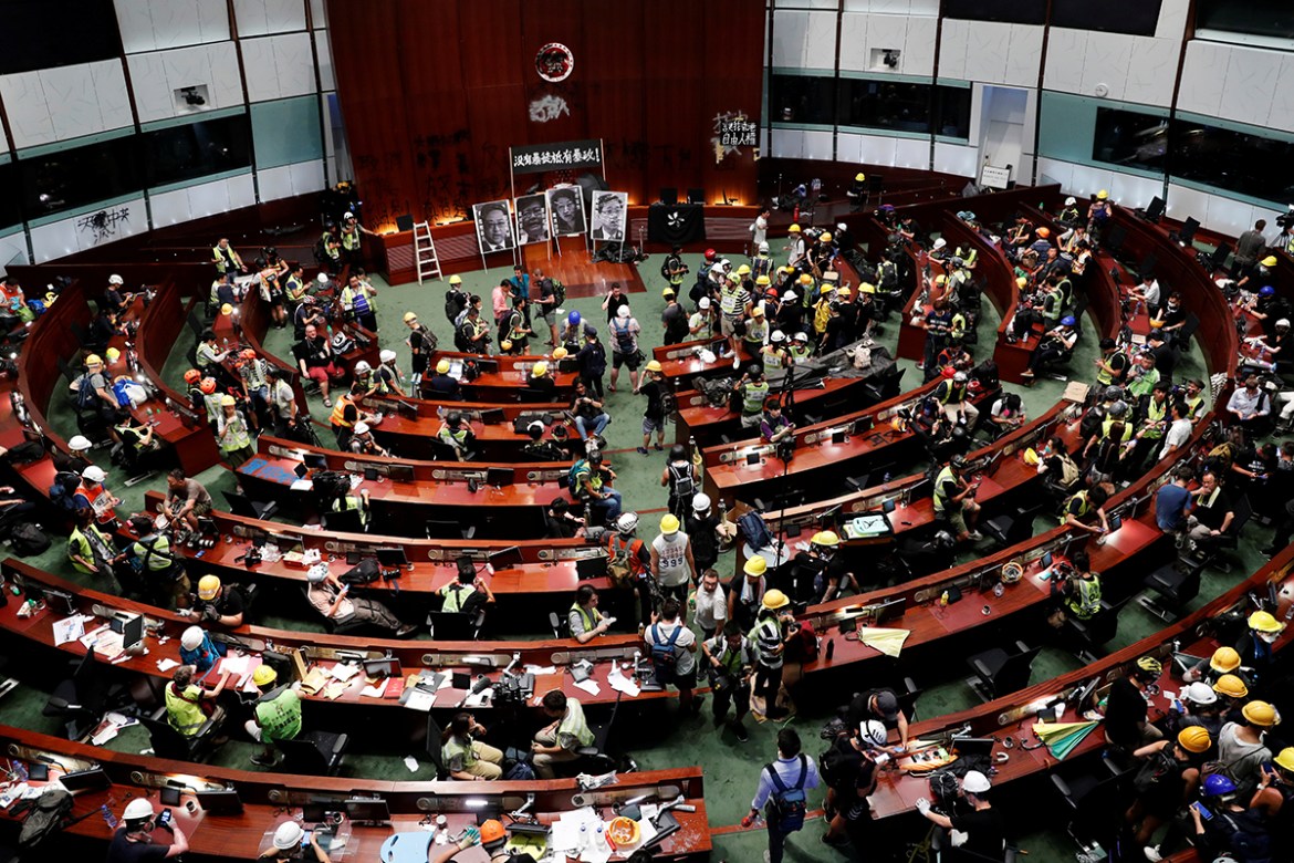 People are seen inside a chamber, after protesters broke into the Legislative Council building during the anniversary of Hong Kong''s handover to China in Hong Kong, China July 1, 2019. The banner read