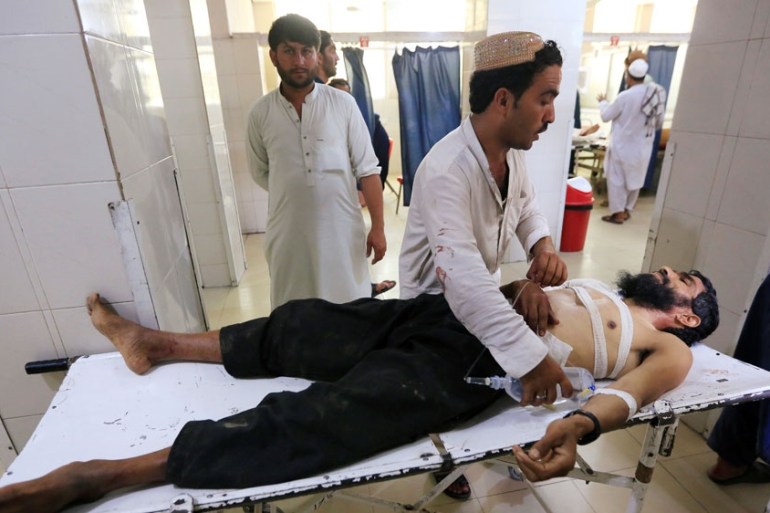 An injured man receives treatment at the hospital, after a suicide attack in Jalalabad, Afghanistan