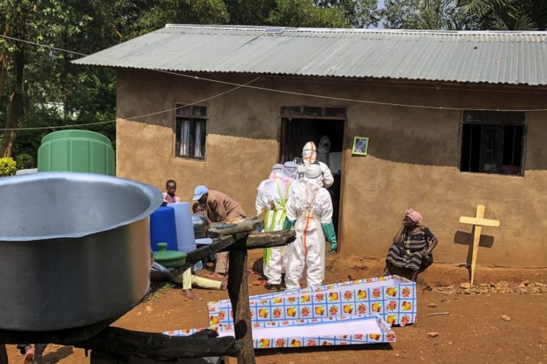 Ebola workers enter a house to decontaminate the body of a woman suspected of dying from Ebola, in Beni, northeastern Congo Monday, June 24, 2019