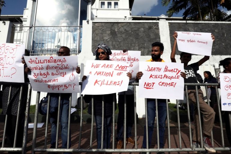 A group of Sri Lankans hold placards during a protest condemning signed death sentences for four people convicted of drug-related offences