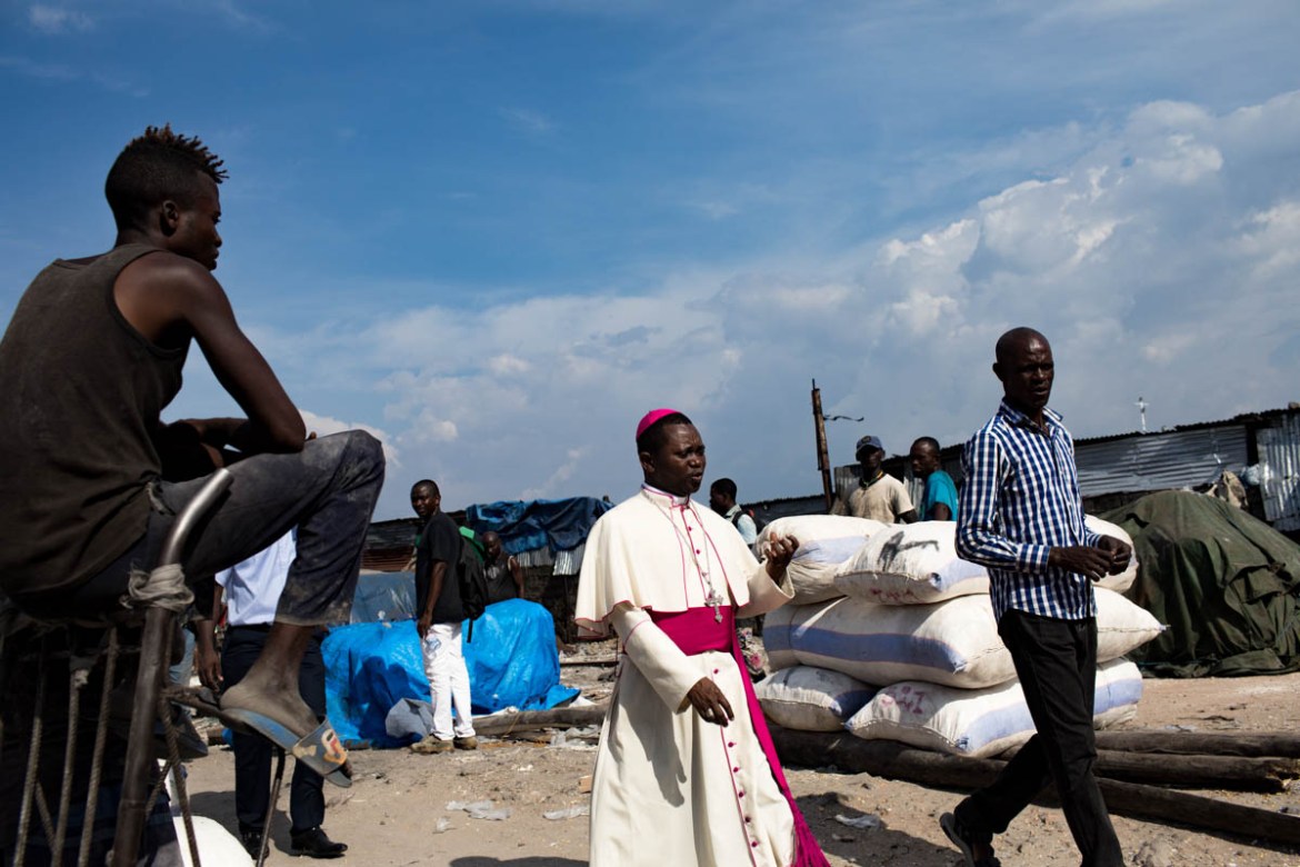 Bishop Emery Kibal, Bishop of the Diocese of Kole, visits the port of Kinshasa. He recently bought a Caritas-funded whaling ship that supplies his isolated diocese with manufactured goods while allowi