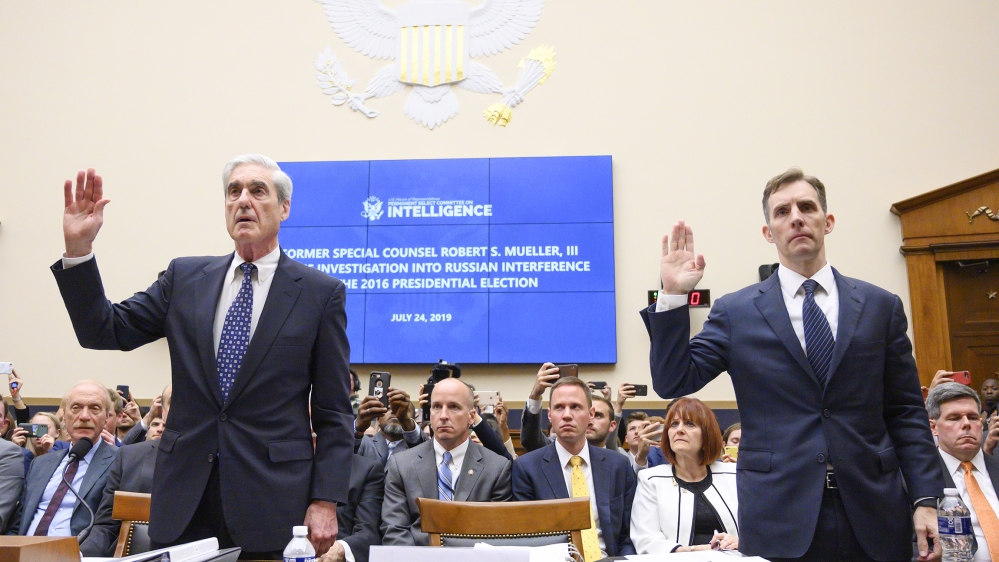 Former Special Counsel Robert Mueller (L) and former Deputy Special Counsel Aaron Zebley are sworn in for testimony before the House Select Committee on Intelligence hearing on Capitol Hill in Washing