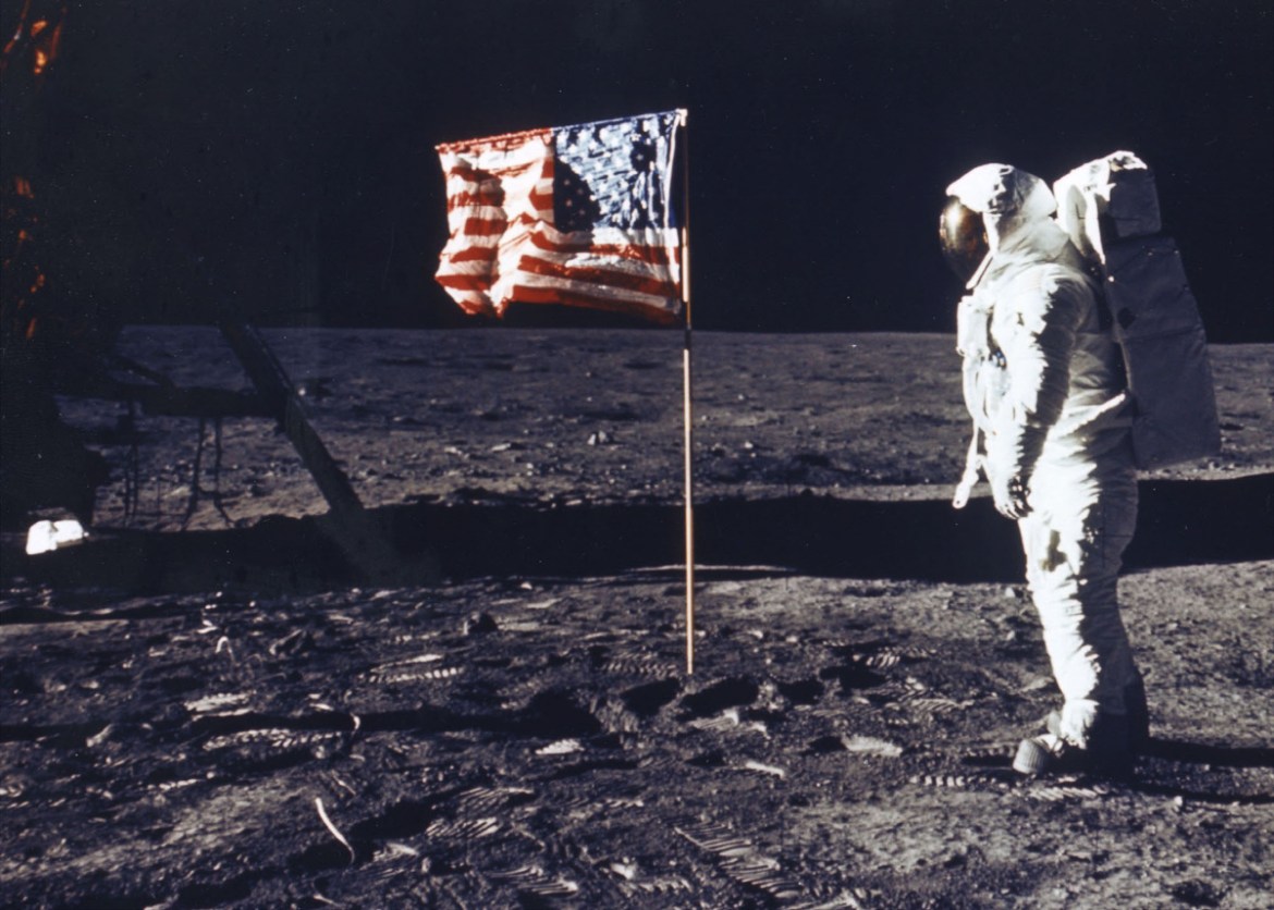 "Astronaut Buzz Aldrin poses for a photograph beside the deployed US flag. [File: Nasa/Getty Images] "