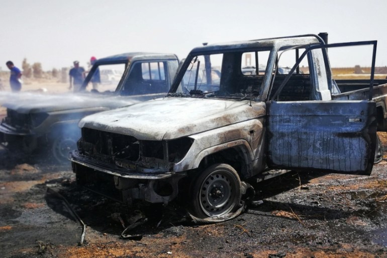Damaged cars are seen at the site where a car bomb hit a funeral of a former senior military commander at Huwari cemetery in Benghazi, Libya July 11, 2019