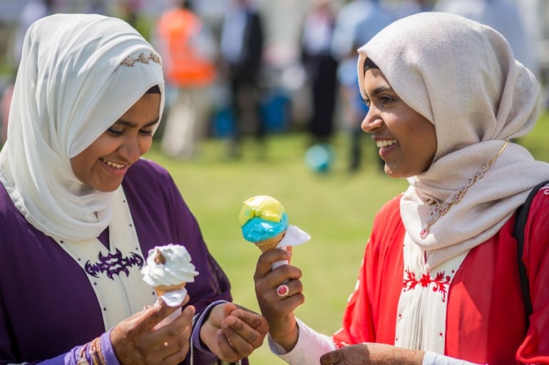 Women eat ice cream as people celebrate the festival of Eid at Southwark Eid Festival in Burgess Park on July 6, 2016 in London, England. Thousands gathered at Southwark Eid Festival in Burgess Park t
