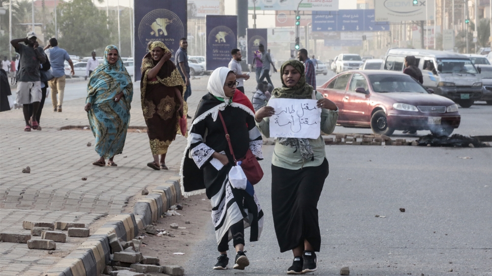 Sudanese protesters carry a placard during a rally in the capital Khartoum to condemn the 