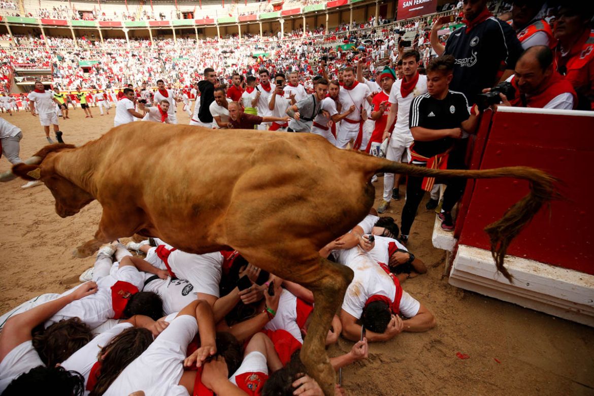 A wild cow leaps over revellers during the running of the bulls at the San Fermin festival in Pamplona, Spain, July 9, 2019. REUTERS/Susana Vera TPX IMAGES OF THE DAY