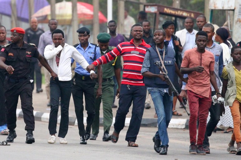 Police officers detain Shi''ite protesters in Abuja