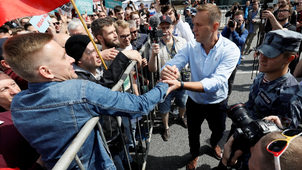 Russian opposition leader Alexei Navalny greets protesters during a rally in Moscow