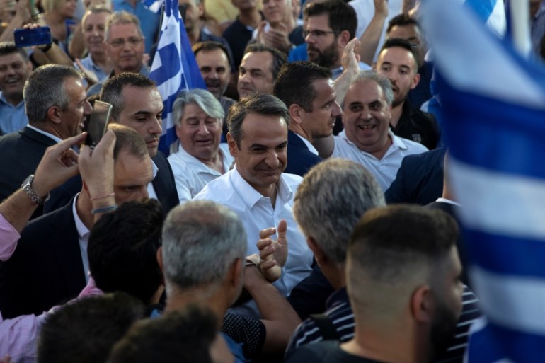 Main opposition New Democracy conservative party leader Kyriakos Mitsotakis is welcomed by supporters during a pre-election rally in Athens