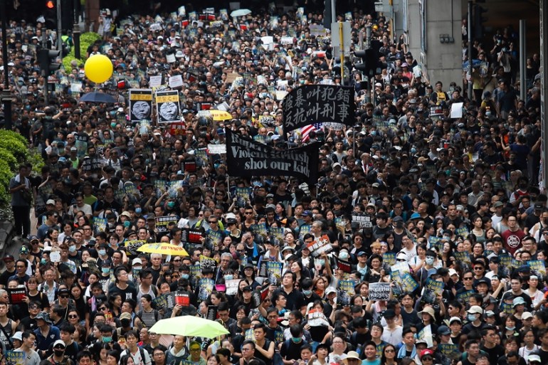 Protesters march through the Sha Tin District in Hong Kong, Sunday, July 14, 2019. Opponents of a proposed Hong Kong extradition law have begun a protest march, adding to an outpouring of complaints