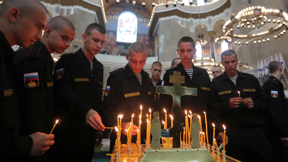 Russian servicemen attend a memorial service for sailors killed in a Russian submarine, which caught fire in the area of the Barents Sea, at the Naval Cathedral of Saint Nicholas in Kronstadt