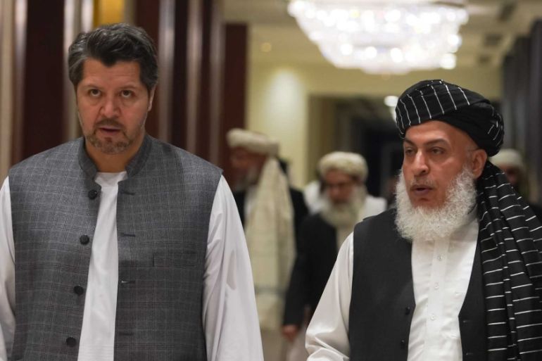 Taliban chief negotiator, (R- the guy with the beard) and Hekhmat Khalil Karzai, deputy foreign minister of Afghanistan (L- the tall younger guy) [Sorin Furcoi/Al Jazeera]