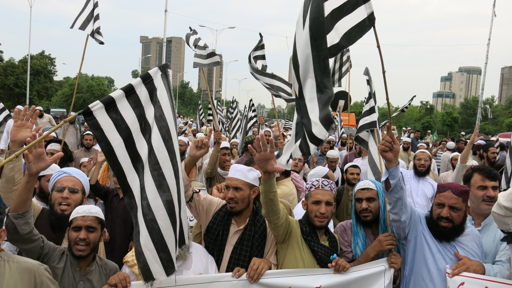 Supporters of the opposition JUI-F party chant slogans at an anti-government protest in the capital Islamabad [Asad Hashim/Al Jazeera]