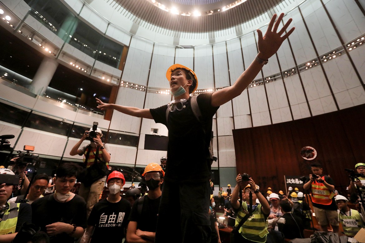 A protester gestures after they broke into the parliament chamber of the government headquarters in Hong Kong on July 1, 2019, on the 22nd anniversary of the city''s handover from Britain to China. Hun