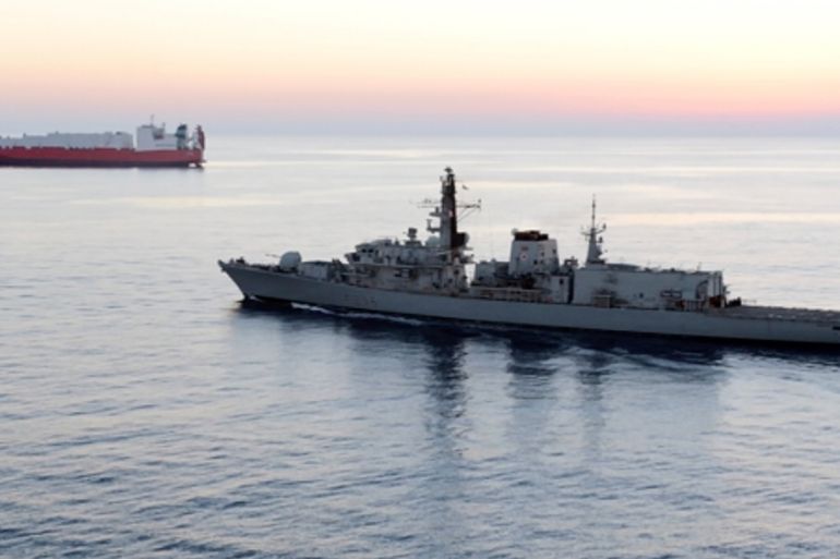 In this image from file video provided by UK Ministry of Defence, British navy vessel HMS Montrose escorts another ship during a mission to remove chemical weapons from Syria at sea off coast of Cypru