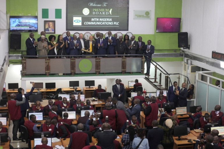 The board of MTN Nigeria Communications PLC joins officials of the Nigerian Stock Exchange to ring the bell to mark the start of trading of MTN shares, in Lagos