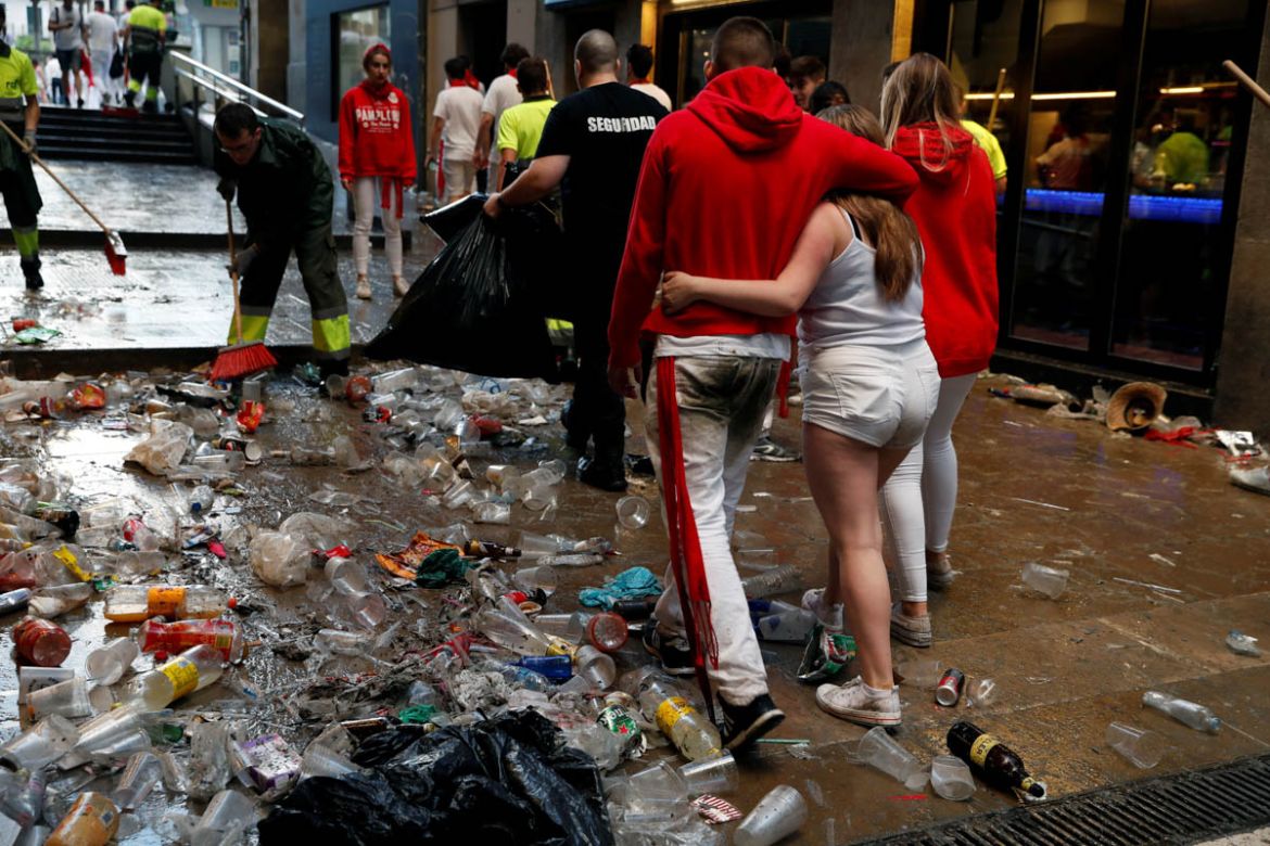 Revellers walks through trash before the second running of the bulls at the San Fermin festival in Pamplona, Spain, July 8, 2019. REUTERS/Susana Vera