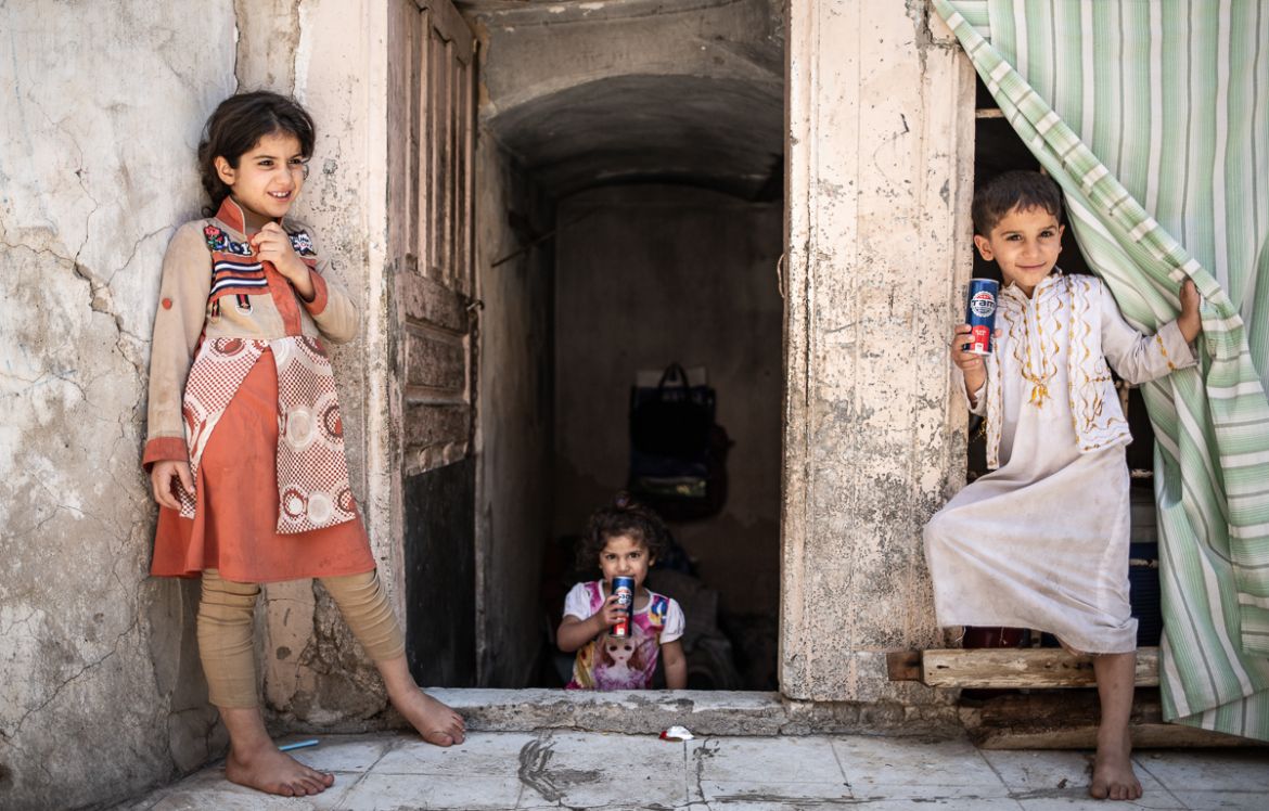 Liqaa''s children at the door of the basement they live in - Old city of Mosul [Tom Peyre-Costa/NRC]