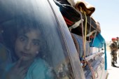 A Syrian refugee girl who left Lebanon looks through a window as she arrives in Qalamoun, Syria June 28, 2018 [File: Omar Sanadiki/Reuters]