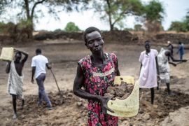 Villagers work to rehabilitate a dry season pond through a food-for-assets initiative funded by the U. S. Agency for International Development’s Office of Food for Peace and implemented by Catholic Re