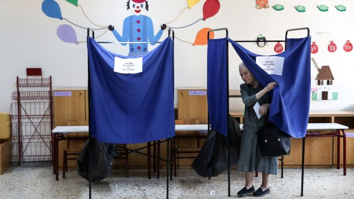 A woman leaves a voting booth to cast her ballot for the general election in Athens, Greece, July 7, 2019. REUTERS/Costas Baltas