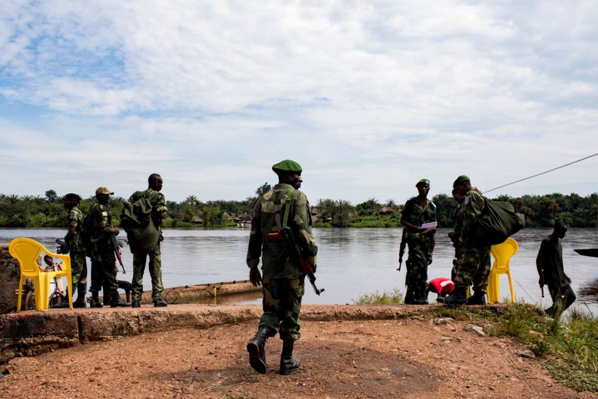 Military personnel from the Armed Forces of the Democratic Republic of Congo (FARDC) wait to cross the Cilemba River to join their assignment on the road between Mbuji-Mayi and Kabinda. In 2017, the a